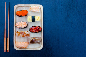 Zushi set is a Japanese dish that is placed on a wooden plate to add beauty to it even more.