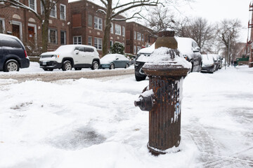 Old Fire Hydrant along a Snow Covered Neighborhood Street in Astoria Queens of New York City during Winter