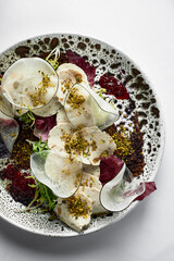 Close up on traditional italian cuisine Vitello tonnato. A dish with pickled veal with tuna cream sauce and bread on wooden background. Copy space for design, text. Snack before lunch. Close up food.
