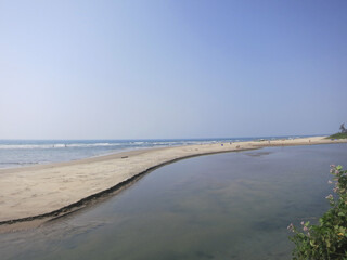 Goa beach, blue cloudless sky, water.