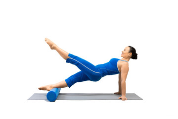 Pilates, core and glutes training. Fit caucasian woman in blue sportswear practice reverse plank drill with foam roller, one leg up, isolated on white.