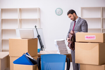 Young male employee in relocation concept