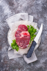 Raw beef steak ossobuco on cutting board