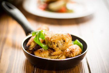 fried pieces of chicken fillet in a pan