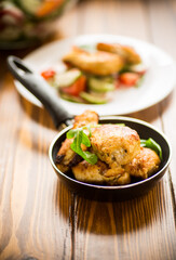 fried pieces of chicken fillet in a pan