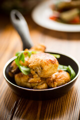fried pieces of chicken fillet in a pan