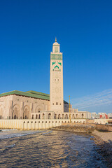 Fototapeta premium Hassan II mosque in Casablanca, Morocco against blue sky background. Islamic culture. 
