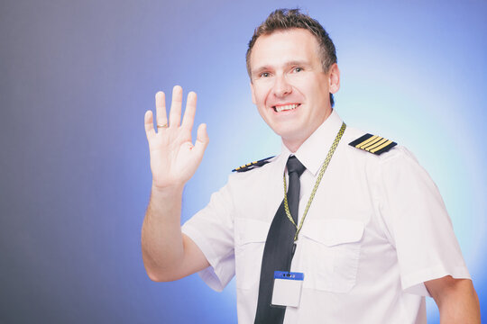 Smiling pilot waving his hand