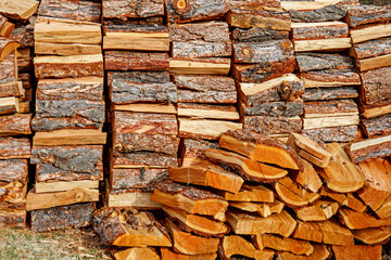 Woodpile of pine firewood close-up. Natural texture in warm colors. 