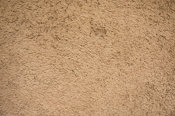 Weathered natural brown clay soil house wall background