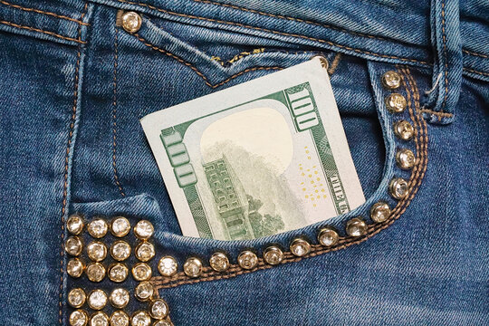 Dollar Bill In The Back Pocket Of Blue Jeans. Cash In Your Pocket.