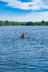 Young men in a kayak on the lake.