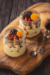 Homemade tiramisu dessert in glass jars.