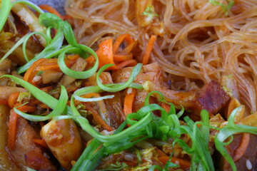 Meat with vegetables, sesame seeds and pasta