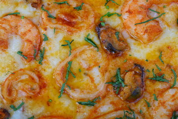 Pizza with mushrooms, sausage and olives on a wooden background