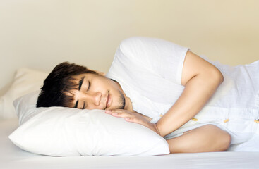 Fototapeta na wymiar asian man sleep on pillow in bed room for relax