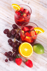 Cocktail drink-orange juice fresh juice with strawberry with lemon orange, mango, pineapple, apple, grapes isolated on white background. High-resolution image