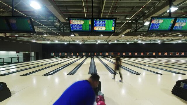 Wide angle time lapse of people at bowling tournament at sport center