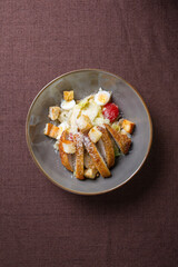 top view Caesar salad with eggs, tomatoes and breadcrumbs and lettuce.