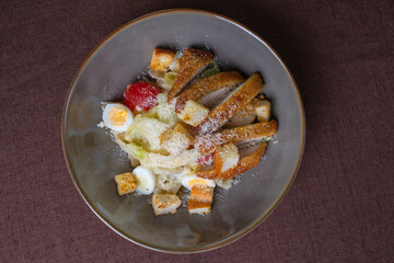 Caesar salad with breadcrumbs and chicken meat top view