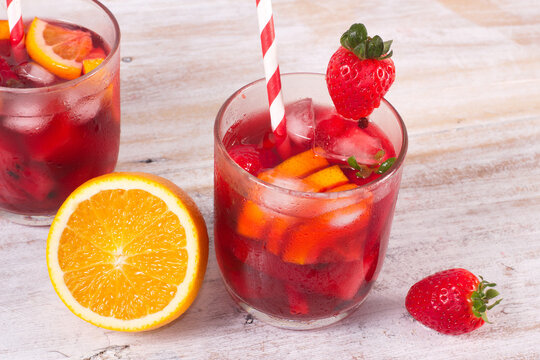 Cocktail drink-orange juice fresh juice with strawberry with lemon orange, mango, pineapple, apple, grapes isolated on white background. High-resolution image