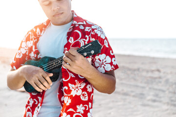 hispanic man holding and playing a stringed instrument or ukulele. chords and music concept.