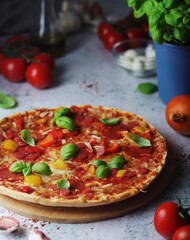 Pizza with salami and basil
