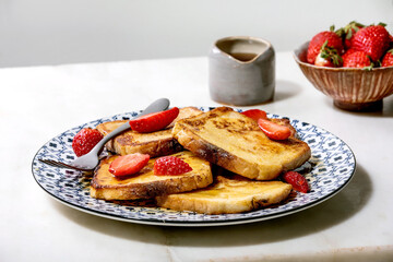 Stockpile of french toasts with fresh strawberries