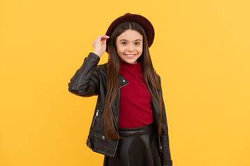 cheerful stylish teen child. kid in hat on yellow background. autumn season trends.
