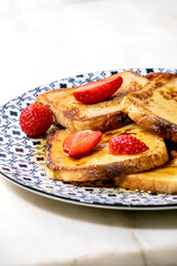 Stockpile of french toasts with fresh strawberries
