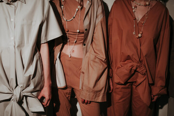 Cropped figures of fashion models women wearing trendy brown beige clothes and accessory. Fashion trendy outfit, female clothes concept.