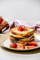 Stockpile of french toasts with fresh strawberries