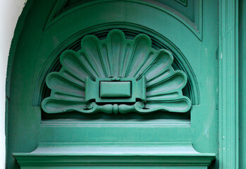 Green detail in the form of a shell, a fan. Decorative element of the exterior door panel. 
Wooden...