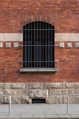 The texture of the building facade. Red and white brick wall. Lattice on the window. 