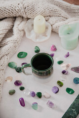 Obraz na płótnie Canvas Hygge and spiritual home concept. gemstones/candle/encent/mug/knitwear