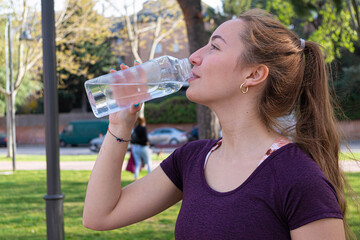 Girl drinking water in a park