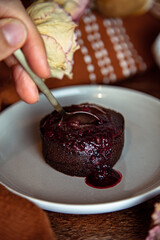 Vegan and gluten free chocolate lava cake with raspberries jam
