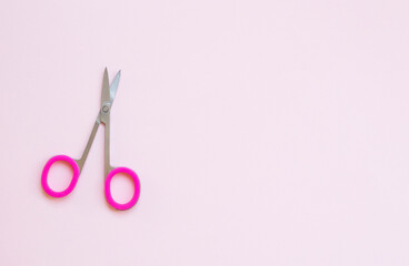 pink scissors on pink background. opy space for text