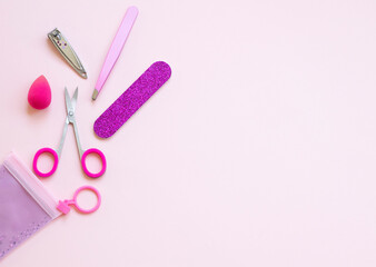 Set of decorative cosmetics.  Manicure tools . tweezers, nail scissors, emery, on pink background. copy space for text