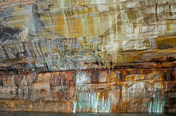 Abstract landscape of a mineral stained cliff along the eroded sandstone shoreline of Lake Superior, Pictured Rocks National Lakeshore, Michigan’s Upper Peninsula, USA