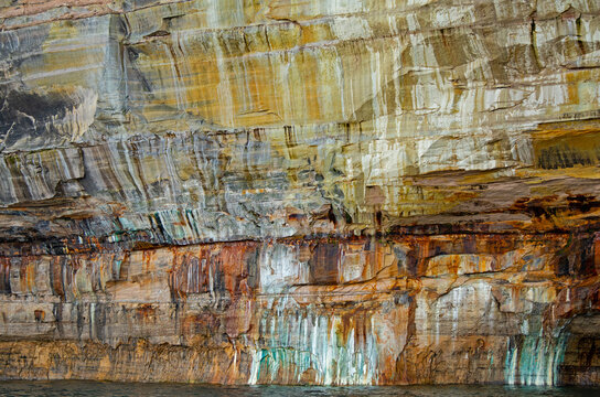 Abstract landscape of a mineral stained cliff along the eroded sandstone shoreline of Lake Superior, Pictured Rocks National Lakeshore, Michigan’s Upper Peninsula, USA - Powered by Adobe