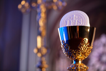 First Holy Communion. Catholic religion theme. Crucifix, the Croass and Golden chalice and wafer on...