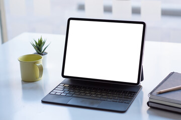 Fototapeta premium Tablet blank white screen place at the table.