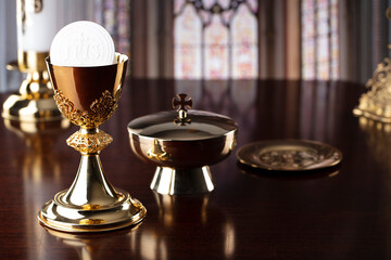 First Holy Communion. Catholic religion theme. Crucifix, the Croass and Golden chalice and wafer on the altar.