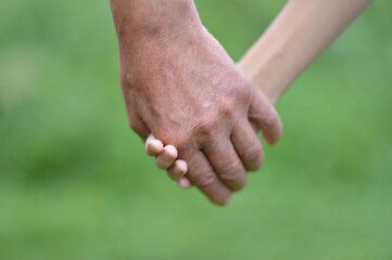 granddaughter and grandfather  holding hands