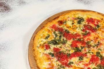 Pizza Homemade Artesanale Close Up Detail on a Round Wooden Plate with Flour Background Table