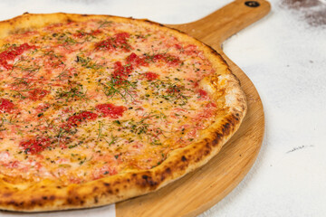 Pizza Homemade Artesanale Close Up Detail on a Round Wooden Plate with Flour Background Table