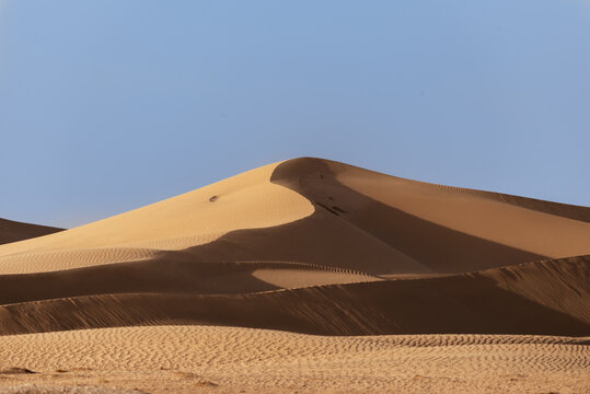 Desert Sand Dunes in the Dubai - UAE, taken at late afternoon showing the contrast in shadows and highlights on the dunes