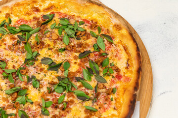 Fried Garlic Pizza with Basil on a Rustic Tomatoe Sauce Homemade Artesanale Close Up Detail on a Round Wooden Plate with Flour Background Table