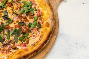 Fried Garlic Pizza with Basil on a Rustic Tomatoe Sauce Homemade Artesanale Close Up Detail on a Round Wooden Plate with Flour Background Table